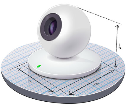 Spherical white webcam placed on a graph paper on which the dimensions of the device are drawn (cut out)