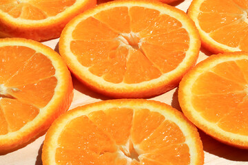 Sliced orange slices stacked in a group, angled view. Ripe juicy orange, close up