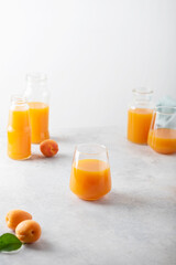 Summer apricot juice on the light background