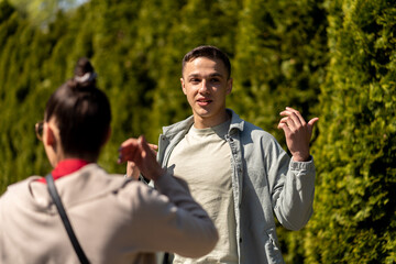 Beautiful happy young couple backside outdoors in spring park