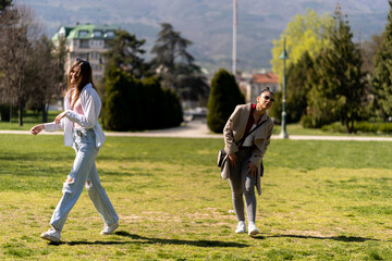 Two female friends talking in park