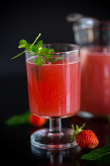 Cold summer strawberry kvass with mint in a glass