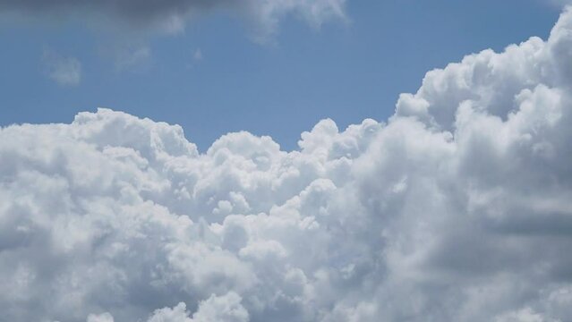 Time lapse of rolling puffy clouds are moving, white clouds time lapse. Clouds running across the blue sky. 4k Timelapse of white clouds with blue sky background