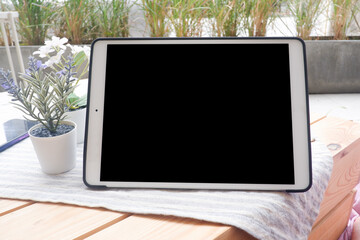 Mockup picture of business woman’s hands using tablet with white blank screen in modern place