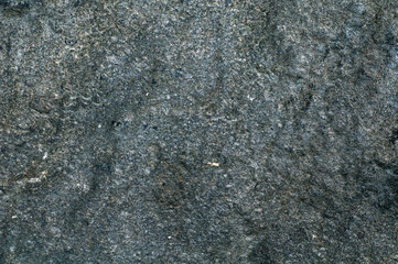 Rock. Background texture of dark stone closeup. Top view, stone from embankment in Poti.