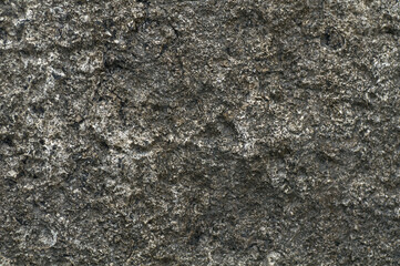 Rock. Background texture of dark stone closeup. Top view, stone from embankment in Poti.