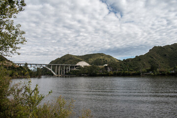Fototapeta na wymiar View over the San Roque Dam of Lake San Roque in Córdoba, in the background the bridge 