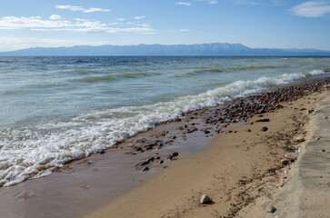 Sandy shore of Lake Baikal in summer weather.