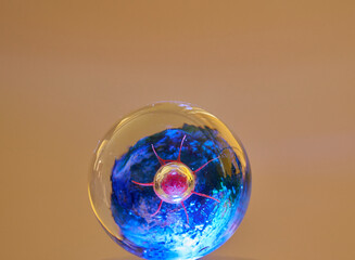 Colored glass paper weight ornament illuminated