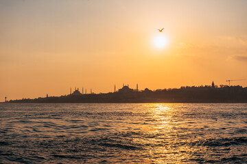 Stunning sunset view from the Ship in Istanbul with segal birds, Hagia Sophia and the blue mosque in Background. 