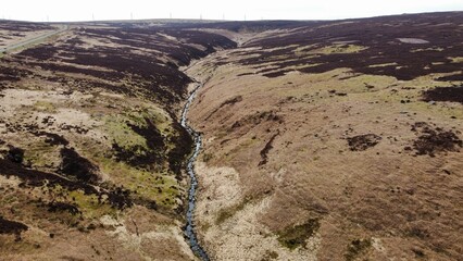 Aerial view of remote countryside with a river and mountains. 