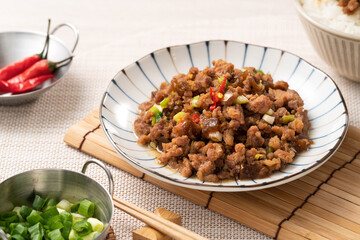 Taiwanese fried minced pork with pickled cucumber on rice named GUA ZI ROU FAN.