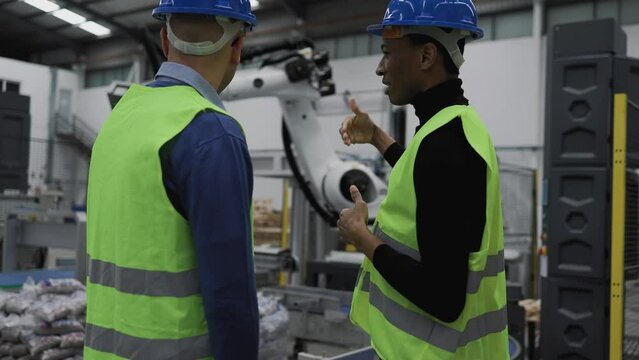 Team of engineers working in robotic factory