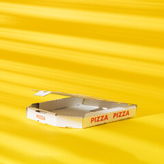 Creative arrangement made of an empty pizza box on a yellow background with shadows. Minimal summer...