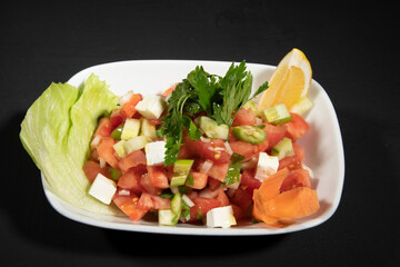 Caprese Salad.Mediterranean Salad. Italian cuisine with mozzarella cherry tomatoes and greens.