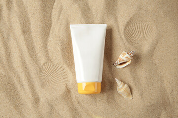sunscreen bottle on sand background