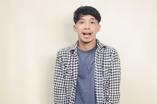 Close Up Portrait Of Happy Young Asian Male Model With Short Black Hair Wearing Plaid Shirt On Isolated Background