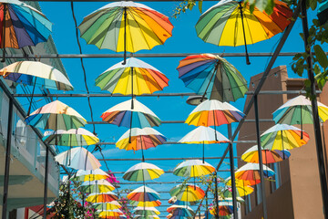 Street decorated with colorful umbrellas in Puerto Plata, Dominican Republic - obrazy, fototapety, plakaty