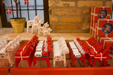 Traditional wooden souvenirs from Denmark - red horses on display at a souvenir shop