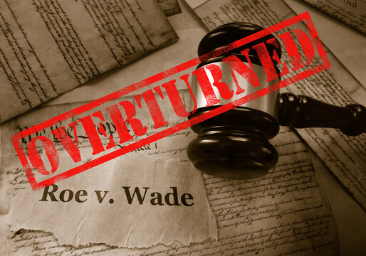  Roe v Wade news headline with gavel and Overturned stamp on the United States Constitution
