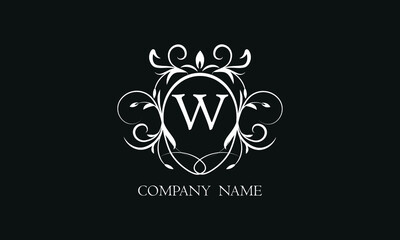 Elegant floral monogram with decorative elements and the letter W. Template for invitations, labels, business. Wedding monograms. Exquisite calligraphic ornament.