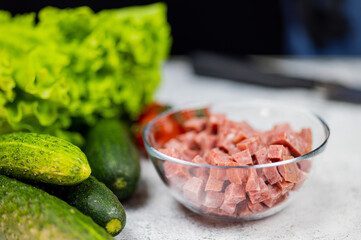 Okroshka - russian national food with meat, potato, kvass or kefir, radish and parsley on white background