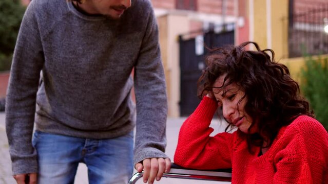 despair, anguish - woman with paraplegia scolded by her boyfriend cries 