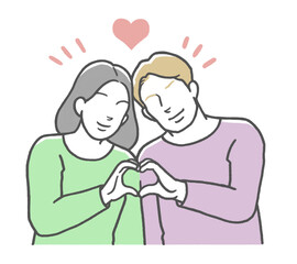 手でハートマークを作る国際カップル　西洋人男性とアジア人女性