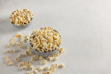 A bowl of delicious popcorn on a light background
