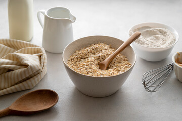 Oat flakes, old fashion close up oat flakes in a bowl. Chocolate oats brownies ingredients, cooking pastry, muffins, baking dessert