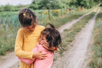 Little friends in strong hugs in nature, day, sunny summer, emotions, children