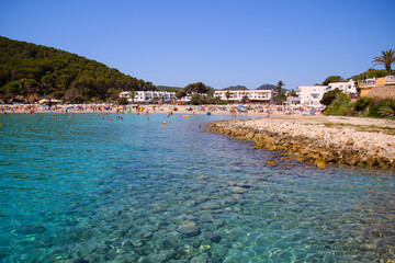 Exceptionally translucent water in the cove of Cala Llonga in the southeast of Ibiza in the Balearic Islands, Spain