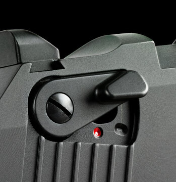 Handgun safety off on a black background