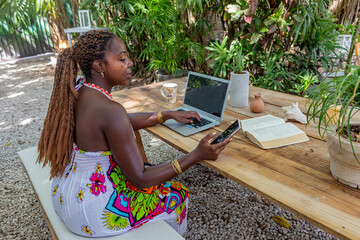 African style woman working at home, in the garden, in nature, working freely