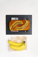 Banana bread on cutting board with Ingredients for Baking. Top view. Vertical photo