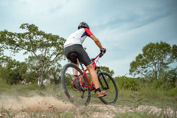 Mountain bikers ride MTB, mountain bike downhill to the extreme. Asian man rides MTB, mountain bike downhill in the wild to extremes. Extreme Sport and MTB, mountain bike downhill Concept.