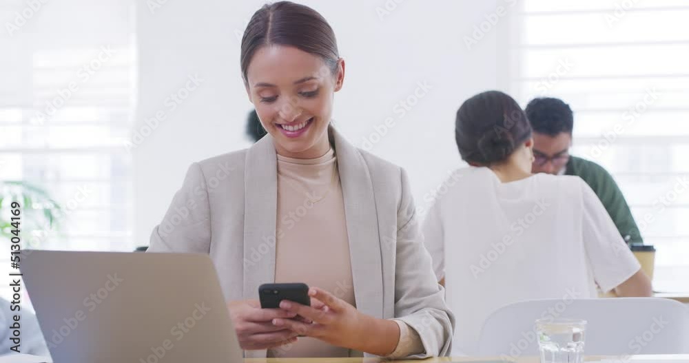 Poster Happy young business woman using a phone to browse the internet while sitting at her desk with a laptop. A working professional checking social media at a startup agency in a modern busy office
