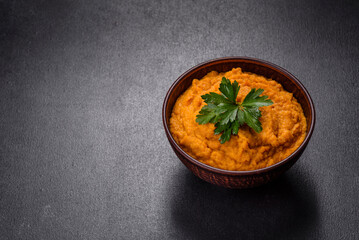 Squash caviar with garlic and tomatoes in a rustic bowl on a dark background