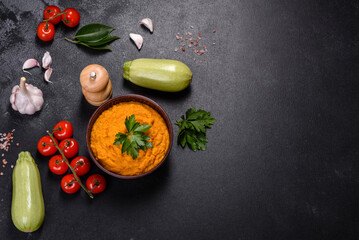 Squash caviar with garlic and tomatoes in a rustic bowl on a dark background
