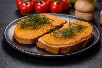 Delicious squash caviar sandwiches on a dark concrete background, healthy breakfast
