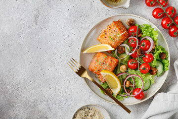 Baked Fried Salmon with fresh vegetables salad, tomatoes cherry, onion, Concept keto diet healthy...