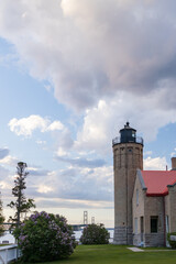 Fototapeta premium Old Mackinac Point Lighthouse at sunset with Mackinac Bridge in background, Mackinaw City, Michigan