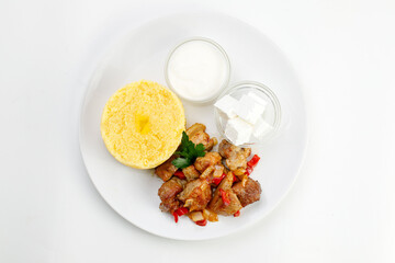 Polenta with Beef steak with cream and cheese on a white background