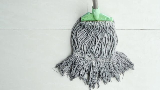 cleaning tiles floor with mop 