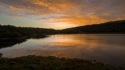 Fototapeta na wymiar A deep orange Sunrise over Loch Aline, Scotland 