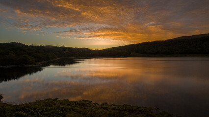 Fototapeta na wymiar A deep orange Sunrise over Loch Aline, Scotland 
