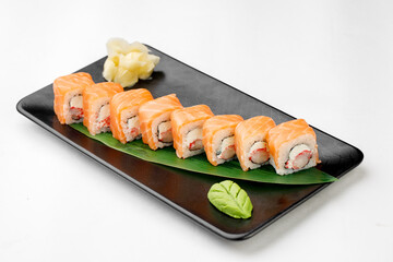 Sushi Philadelphia on black plate and white background