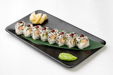 Sushi rolls on black plate and white background