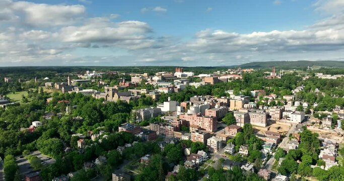 Late afternoon summer scenic aerial video of Ithaca NY, College Town.