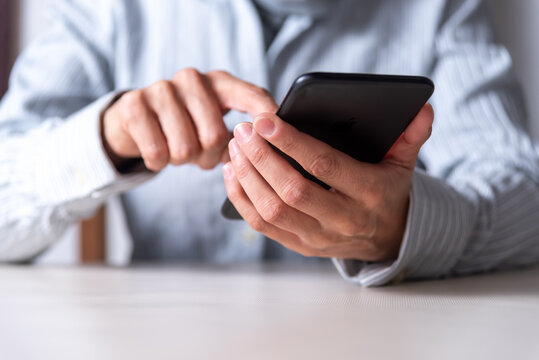 Close up thin hands clicking on a mobile phone, communication concept, networks and communications, selective focus